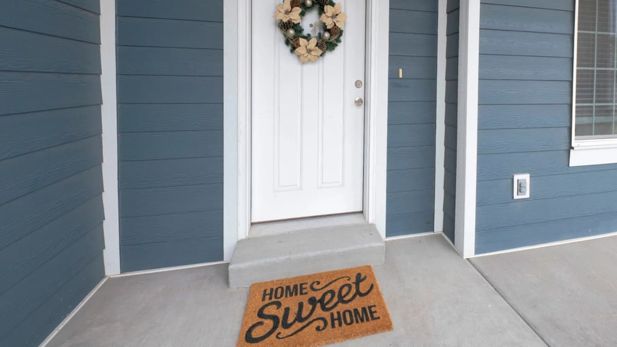 Blue fiber cement siding surrounding a white front door in Forest Lake, MN
