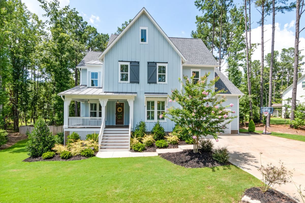 Two-story home with fresh exterior paint, white trim, and a covered front porch