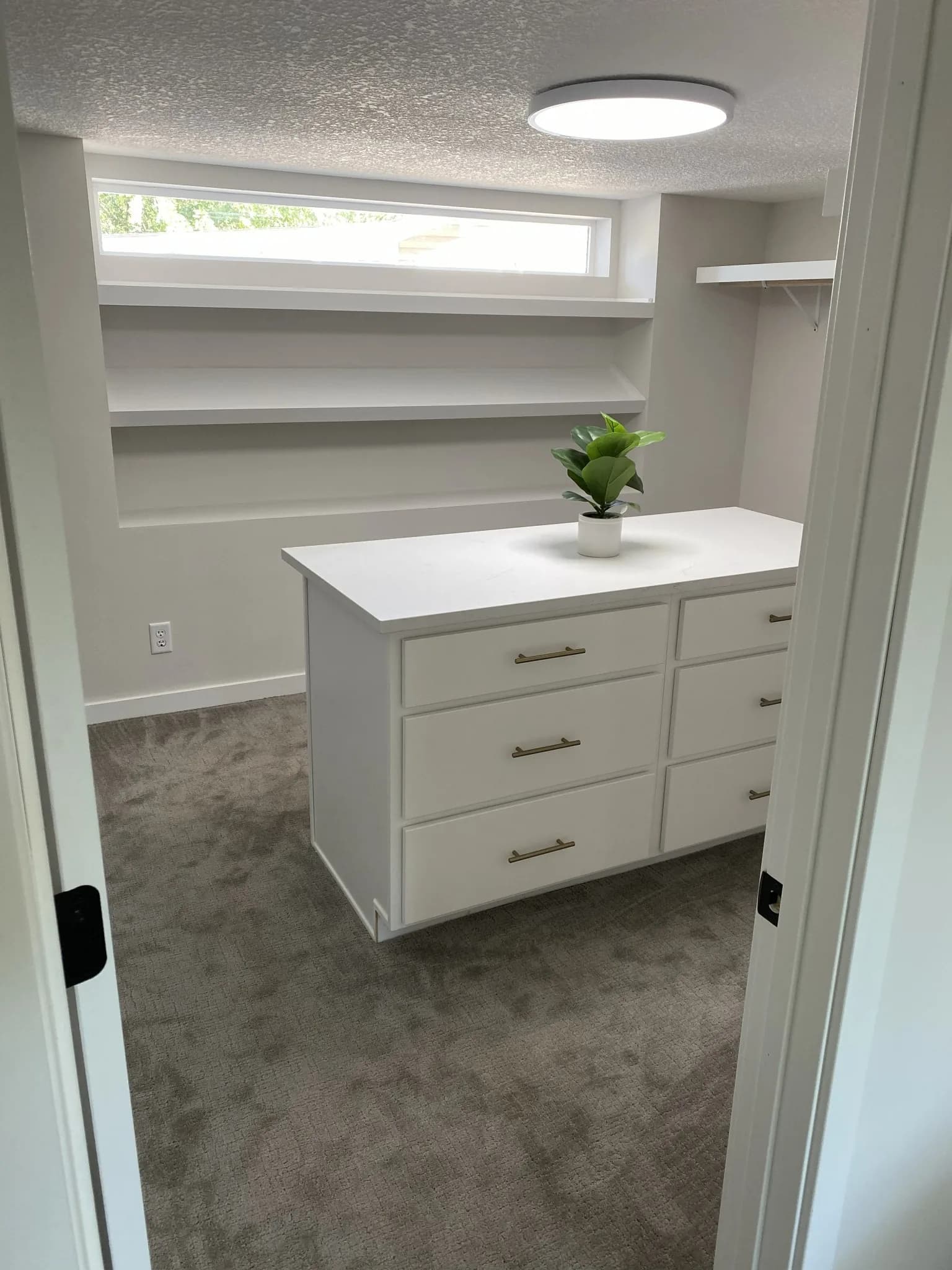 Walk-in closet carpentry with custom island in a Forest Lake, MN home